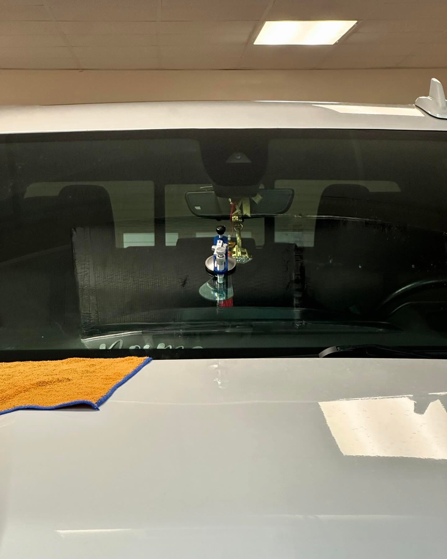 Stone-chip repair equipment attached to a vehicle windshield